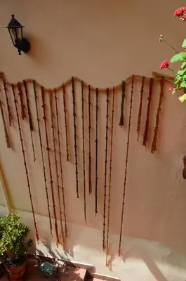 a curtain made out of yarn hanging on a wall at Casona les Pleiades in Cusco