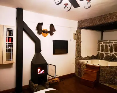 a living room with a fireplace and a tub at Cities of the World - Apartments Cusco in Cusco