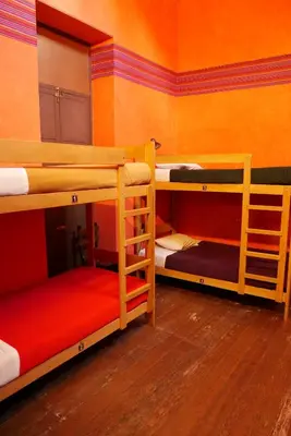 a room with three bunk beds in a room at KACLLA, The Healing Dog Hostel in Lima
