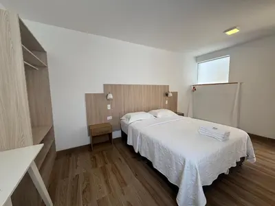 a bedroom with two beds and a window at Betania in Paracas