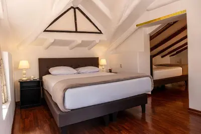 a bedroom with a large bed and a window at Tika Wasi Casa Boutique in Cusco