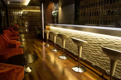 a bar with a row of stools and a counter at NM Lima Hotel in Lima