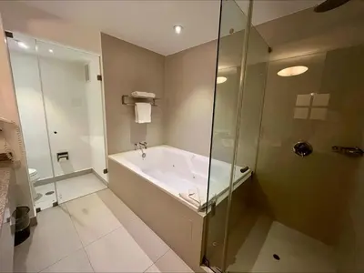 a bathroom with a bath tub and a shower at NM Lima Hotel in Lima