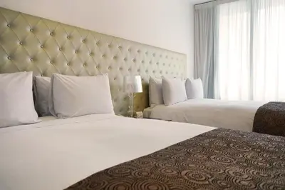 a hotel room with two beds and a large window at NM Lima Hotel in Lima