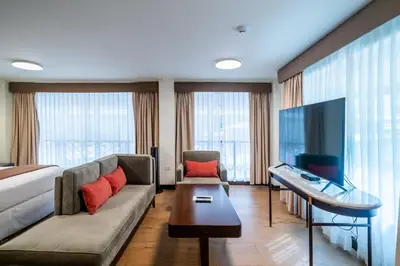 a hotel room with a couch and a table at Hotel Taypikala Machupicchu in Machu Picchu