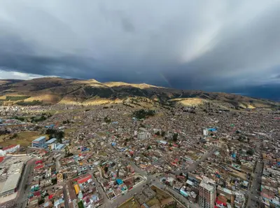 an aerial view of a city with buildings and mountains at Hotel Unu in Huancayo