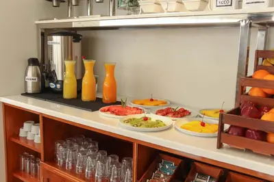 a buffet with plates of food on a shelf at Hotel Unu in Huancayo