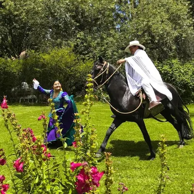 a man is riding a horse with a woman at Las Casitas del Arco Iris in Urubamba