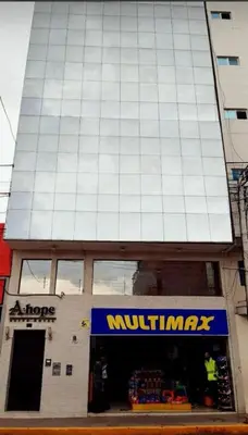 a store front of a building with a muppet nutrats sign at A-Hope Suite Hotel in Huancayo