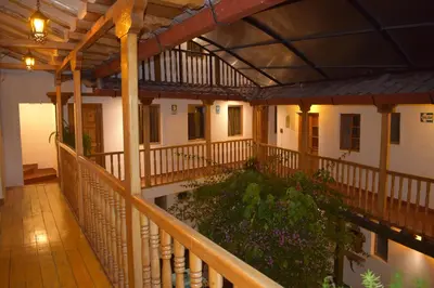 an indoor balcony of a building with a garden at Huascaran Casa Boutique San Blas in Cusco