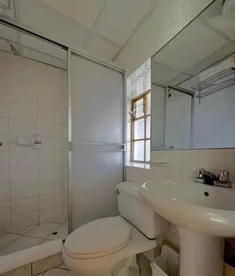 a bathroom with a toilet and a sink and a shower at Huascaran Casa Boutique San Blas in Cusco