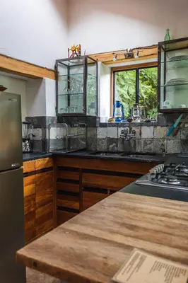 a kitchen with a counter top and a refrigerator at El Albergue Ollantaytambo in Ollantaytambo