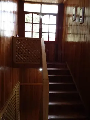 a staircase in a building with a window and a stair case at La Cabaña de Noa in Oxapampa