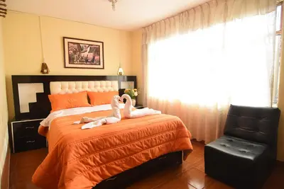 two swans sitting on a bed in a bedroom at Tambo Cusco Inn in Cusco