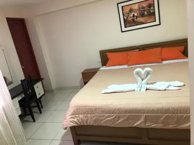 a bedroom with a bed with towels on it at Tambo Cusco Inn in Cusco