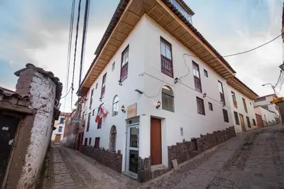 a white building on the side of a street at Hotel Luna de Oro Cusco in Cusco
