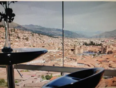 a view of a city from a room with a table at Hotel Luna de Oro Cusco in Cusco
