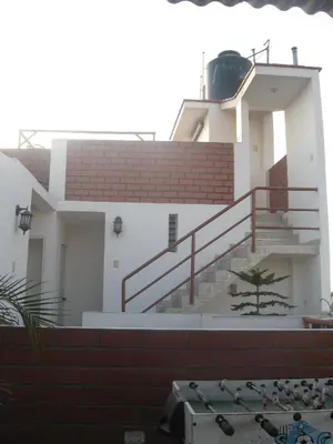 a building with a staircase on the side of it at Posada Peregrinus in Lima