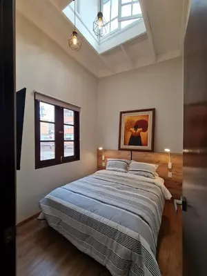 a bedroom with a large bed with a blue blanket at Flying Dog Lima B&B in Lima