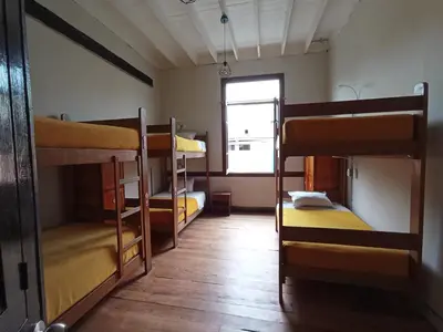 a room with three bunk beds and a window at Flying Dog Lima B&B in Lima