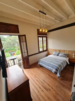 a bedroom with a bed and a large window at Flying Dog Lima B&B in Lima