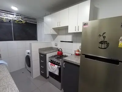 a kitchen with a stainless steel refrigerator and a dishwasher at Peruvian Apartment in Lima