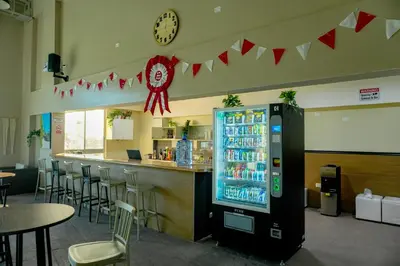 a soda machine in a restaurant with a bar at El Paraíso Eco Resort in Pisco