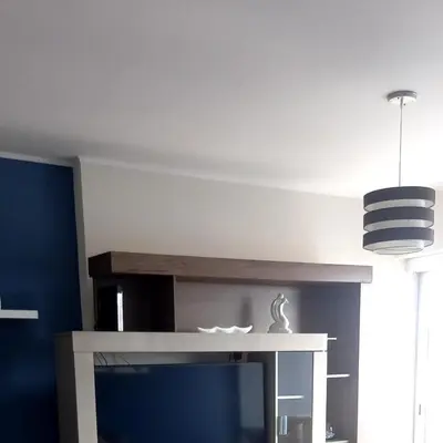 a living room with a tv and a blue wall at Miraflores Heart Apartment in Lima