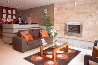 a man standing at a counter in a living room at SM Hotel in Lima