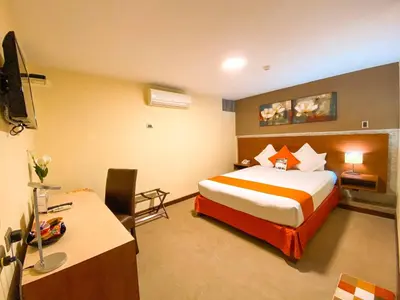 a hotel room with a bed and a desk at SM Hotel in Lima