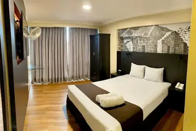 a hotel room with a bed and a window at Hotel María Luisa in Lima