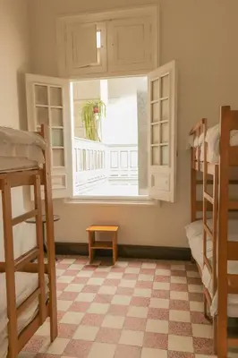 a room with two bunk beds and a window at 1900 Backpacker's Hostel in Lima