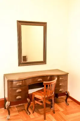 a desk with a chair and a mirror on a wall at 1900 Backpacker's Hostel in Lima