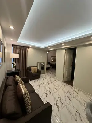 a large living room with a couch and a living room with at Solis Dies Hotel in Lima