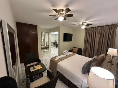 a hotel room with a bed and a ceiling fan at Solis Dies Hotel in Lima
