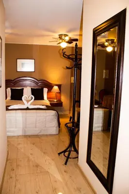 a bedroom with a bed with a large mirror at Solis Dies Hotel in Lima