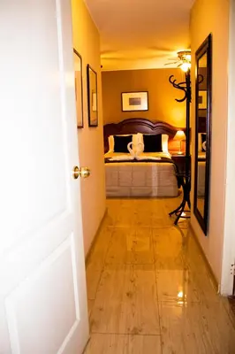 a bedroom with a bed in the corner of a room at Solis Dies Hotel in Lima