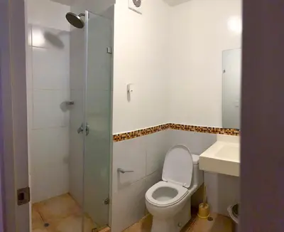 a bathroom with a toilet and a sink and a shower at Condominio Uptown de 2 dormitorios in Lima
