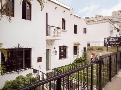 a white building with a black fence at Hotel Señorial in Lima