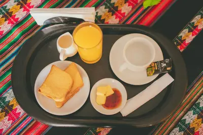 a black tray with breakfast foods on a table at Hotel Excalibur in Lima