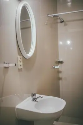 a bathroom with a sink and a mirror and a shower at Hotel Excalibur in Lima