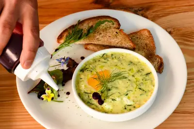 a plate of food with a bowl of soup and toast at Cooper Hotel Boutique in Cusco