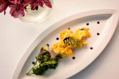 a white plate with food on a table at Cooper Hotel Boutique in Cusco