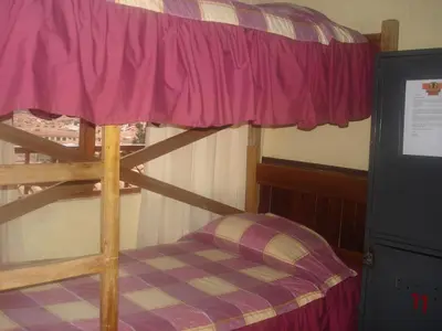 a bunk bed in a room with a pink canopy at Samay Wasi Hostel in Cusco