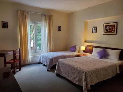 a hotel room with two beds and a window at The Place Miraflores in Lima