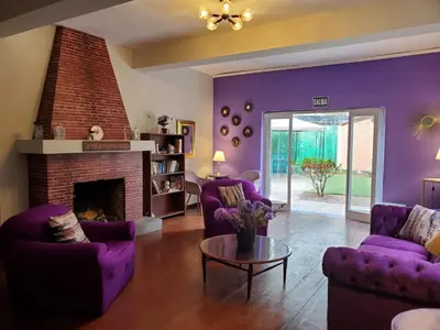 a living room with purple furniture and a fireplace at The Place Miraflores in Lima