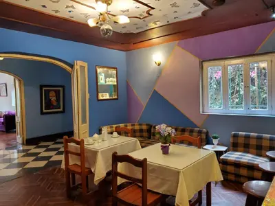 a dining room with two tables and chairs at The Place Miraflores in Lima