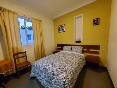 a bedroom with a bed and a window at The Place Miraflores in Lima