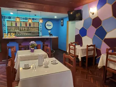 a restaurant with two tables and a bar at The Place Miraflores in Lima