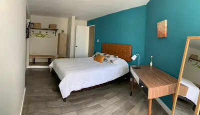 a bedroom with a bed and a wooden table at MLA apartments - 28 de Julio in Lima